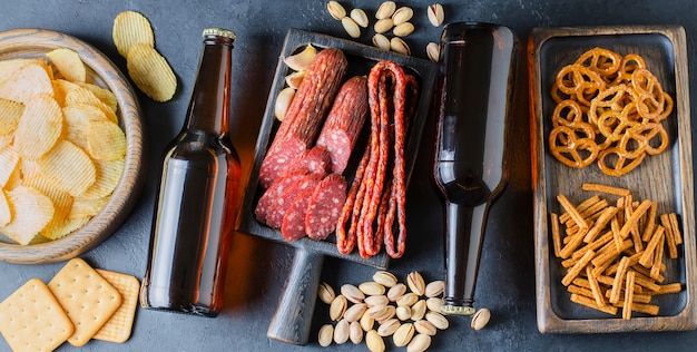 Beer in glass bottles and salty snacks for beer