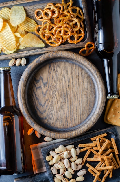 Beer in glass bottles and salty snacks