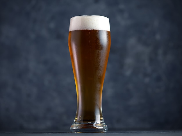 Beer glass on a dark table close up