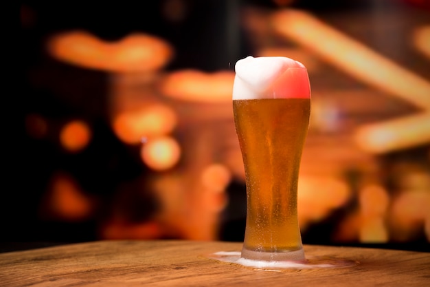 Beer glass in front of blurred background