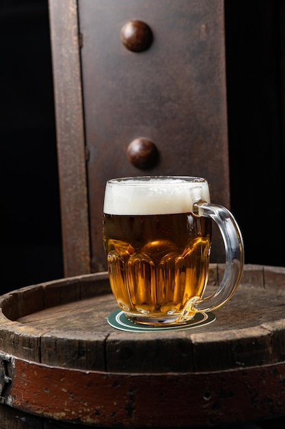 beer in a glass stands on a beer barrel in a restaurant