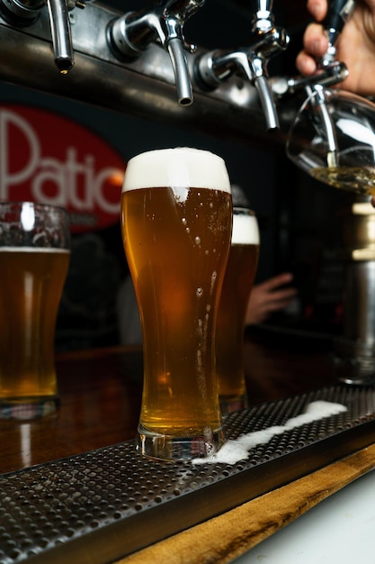 Beer glass with foam in a bar