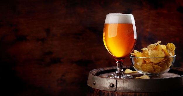 Beer glass on wooden barrel