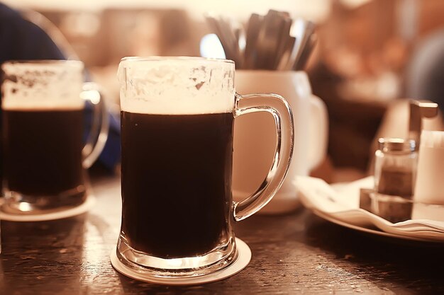 beer mug on a blurred background / beer restaurant beautiful dark beer in a mug in the interior of a pub