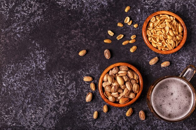 Beer and nuts on stone background