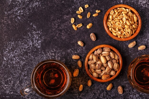 Beer and nuts on stone .