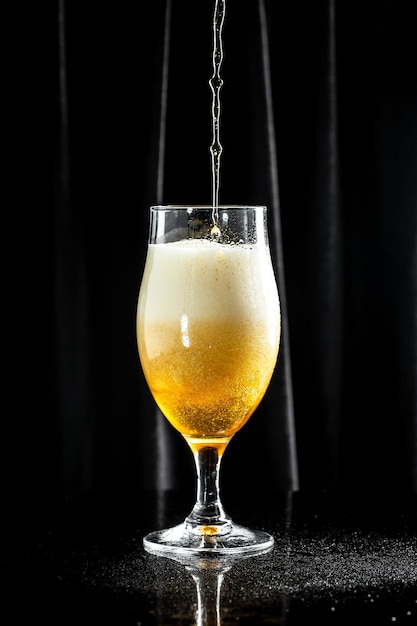 Beer pouring beer into glass with thick foam