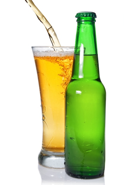 Beer pouring from into glass isolated with bottle on white