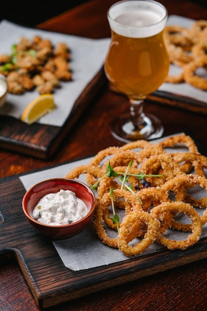 Beer set appetizers fried onion rings with tartar sauce