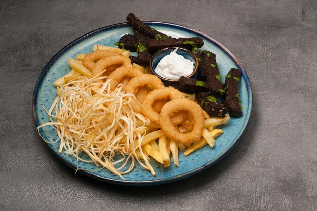 Beer snacks onion rings garlic croutons cheese with sour cream sauce