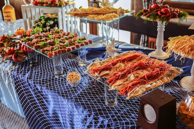 Beer table at the wedding reception Crisps and fish for guests Tasty snacks