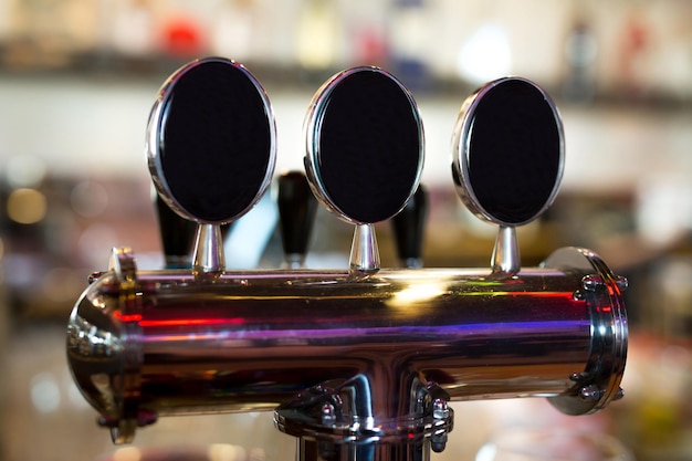 Photo beer on tap in a pub in a row .