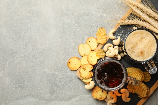 Beer, wheat and snacks on gray 