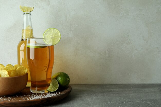 Beer with snacks against white textured