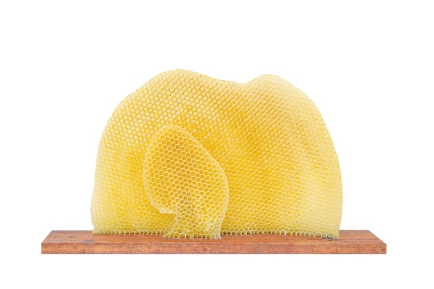 beeswax filled with honey on a wooden board