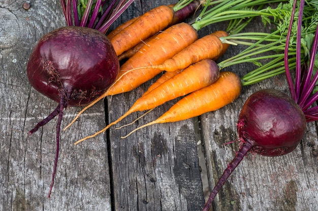 Beet and carrot on a old wooden table.