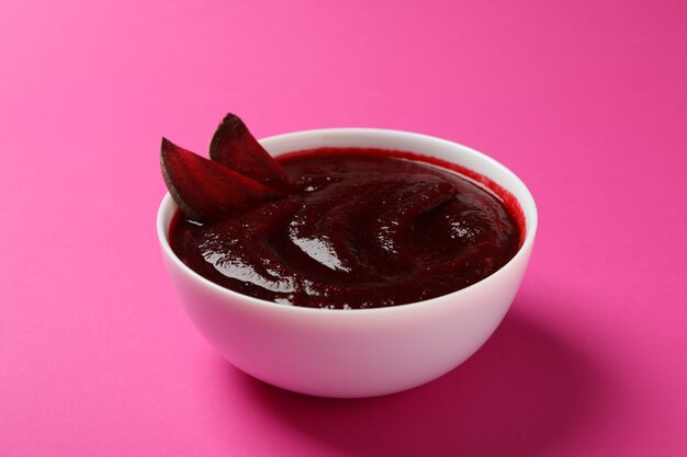 Beet cream soup on pink, close up