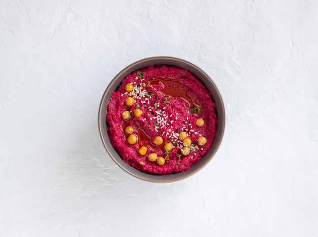 Beet hummus in a gray bowl. Healthy eating. Vegetarian food.