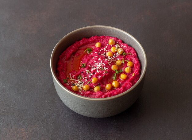 Beet hummus in a gray bowl. Healthy eating. Vegetarian food.