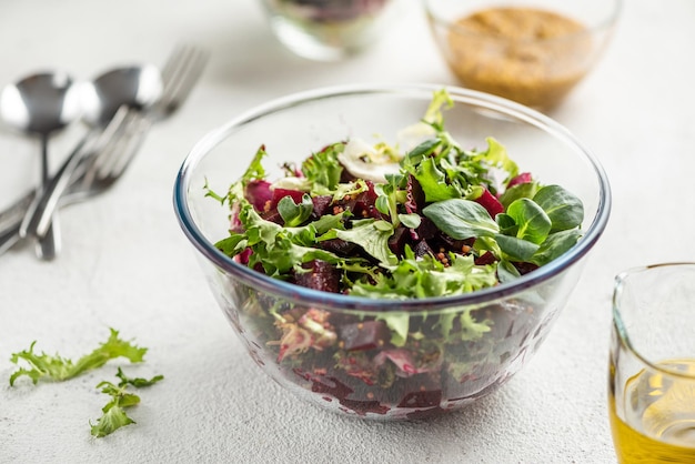 Beet salad with oil and greens White background