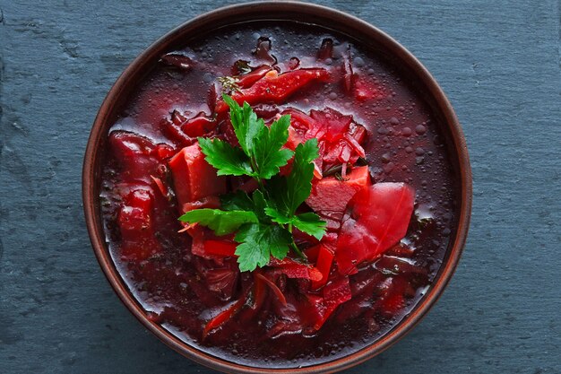 Beet soup in a bowl. Fresh vegetable soup with beets. Top view.