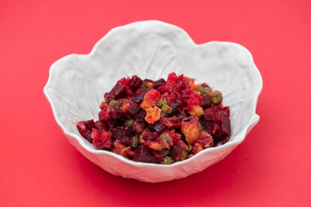 Beetroot and boiled vegetables traditional Russian homemade salad in bowl