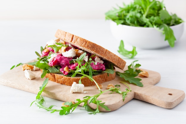 Beetroot and feta cheese sandwich with walnuts and rocket