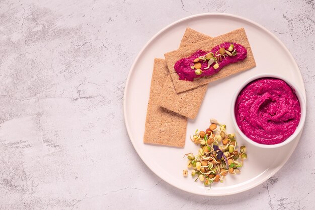 Beetroot hummus sprouted grains and whole grain crisps