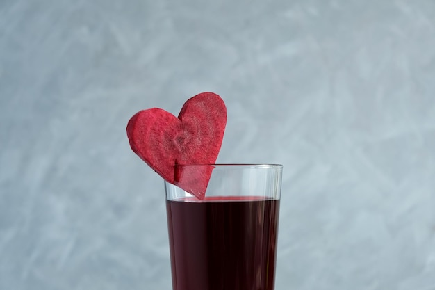 Beetroot juice closeup Glass of red beverage decorated slice of beet heart shaped Salgam