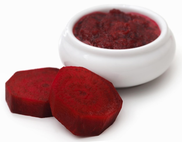 Beetroot paste in a bowl over white background