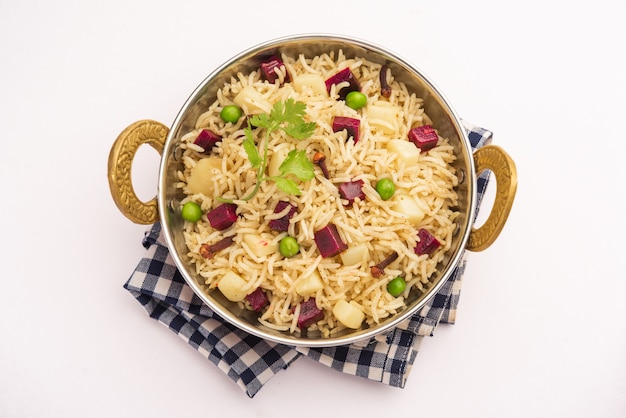 Beetroot Rice or pulao or pulav served in a bowl or karahi, selective focus. Indian food