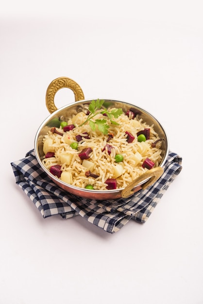 Beetroot Rice or pulao or pulav served in a bowl or karahi, selective focus. Indian food