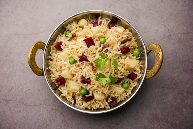 Beetroot Rice or pulao or pulav served in a bowl or karahi, selective focus. Indian food