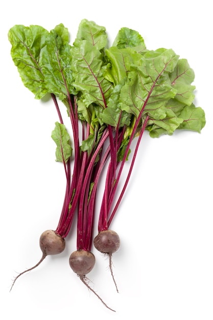 Beetroots or red beets with green leaves on white background