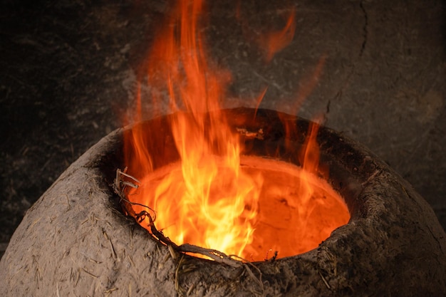 Before you bake bread in the clay oven you have to make a fire