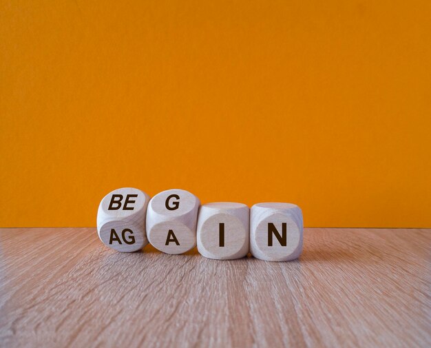 Begin again symbol turned wooden cubes and changes the words begin to again