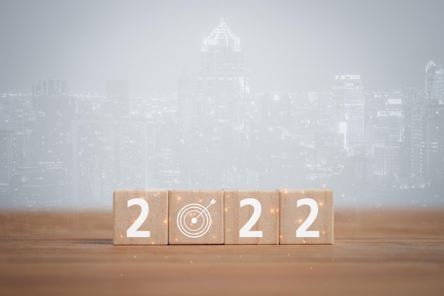 Beginning business successful wood cubes with New year 2022 and goal or target icon concept Business goals and vision