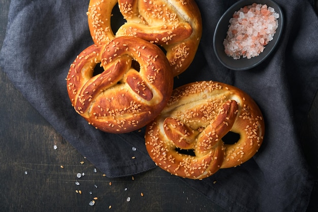 Beierse pretzels en glas pils Oktoberfest-voedselmenu traditionele gezouten pretzels over oude donkere houten achtergrond Bovenaanzicht met ruimte voor tekst Oktoberfest-thema