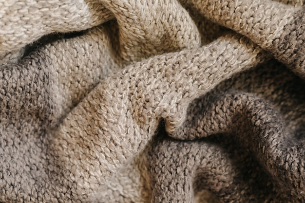 Beige autumn knitting wool texture background.