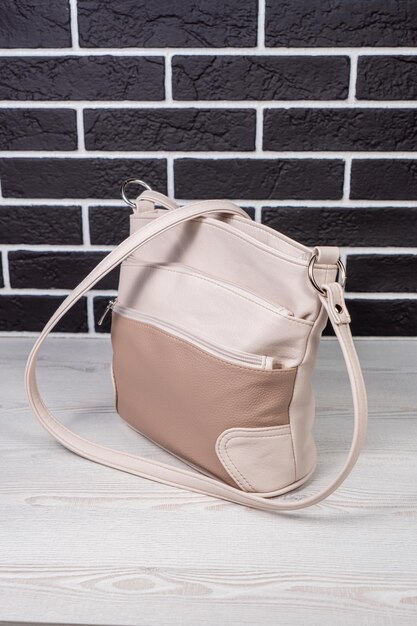 A beige bag with a strap that says'no 1'on it