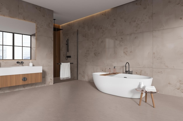 Beige bathroom interior with sink douche and bathtub with accessories