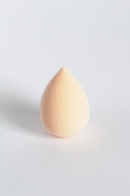 Beige beauty blender isolated on a white background.Closeup shot