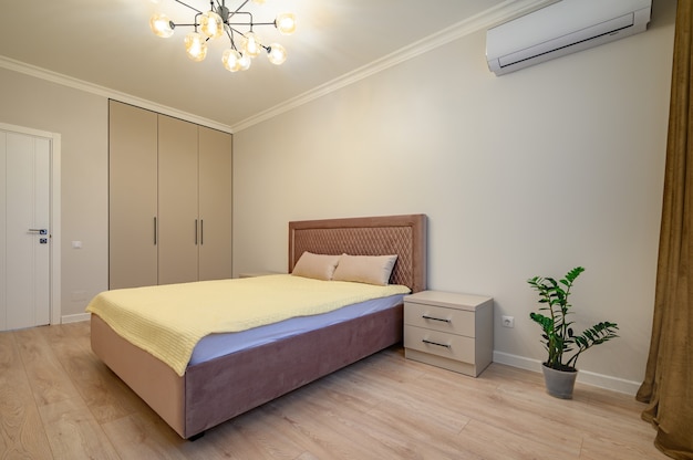 Beige and brown modern bedroom interior with double bed