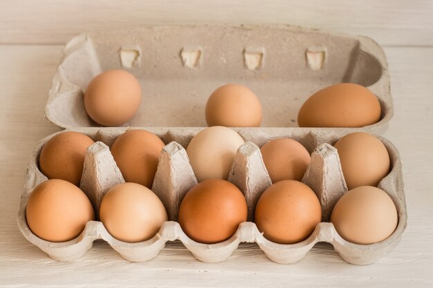 Beige chicken eggs in a carton