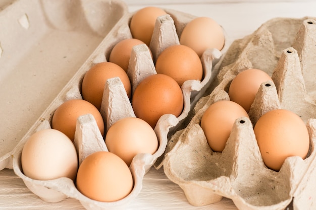 Beige chicken eggs in a carton