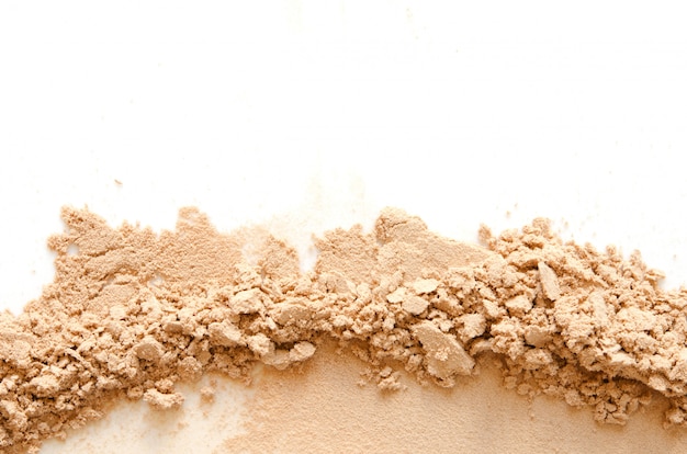 Beige crashed face powder for makeup as sample of cosmetic product, isolated