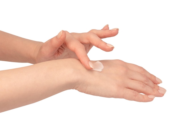 Beige cream tube in woman hands isolated on a white background Cream swatch on woman hand