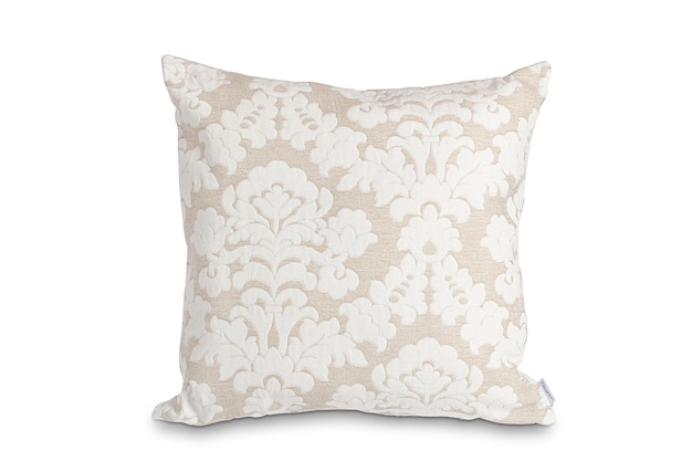 A beige cushion with a floral pattern on it.