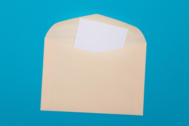 Beige envelope with blank white sheet of paper inside