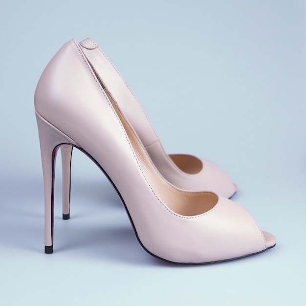 Beige high heel shoes on white.